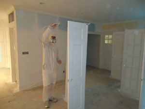 Spray painting the interior doors on a Duxbury home.
